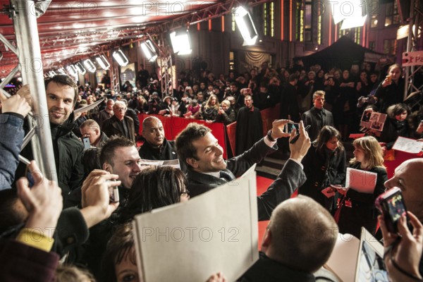 DEU Germany Germany Berlin 64th Berlinale, the international film festival in the German capital. Film premiere in Friedrichsstadtpalast with Bradley Cooper taking pictures of himself with a fan's smartphone