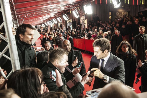 DEU Germany Germany Berlin 64th Berlinale, the international film festival in the German capital. Film premiere in Friedrichsstadtpalast with Bradley Cooper, who took a photo of himself with a fan's smartphone