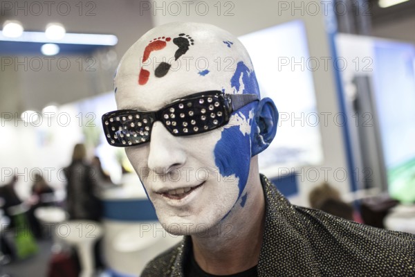 DEU Germany Germany Berlin International Tourism Exchange ITB. A man with a painted head, on which the world map can be seen, promotes his Internet portal