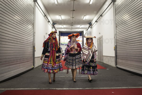 DEU Germany Germany Berlin International Tourism Exchange ITB. South American hostesses walk through a crossing between two exhibition halls