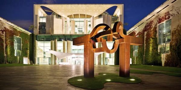Illuminated Federal Chancellery in the evening with the sculpture entitled Berlin by Eduardo Chillida, Government District, Berlin-Mitte, Berlin, Germany