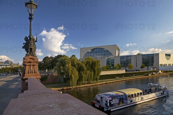View of the Reichstag and the Federal Chancellery from the Moltke Bridge with an excursion boat on the Spree River, Government District, Berlin, Germany