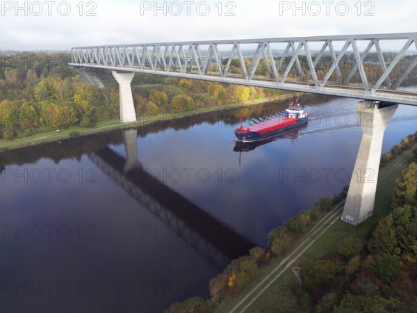 Cargo ship sails under the Grünental High Bridge in autumn through the Kiel Canal, NOK, Kiel Canal, Kiel Canal, Schleswig-Holstein, Germany