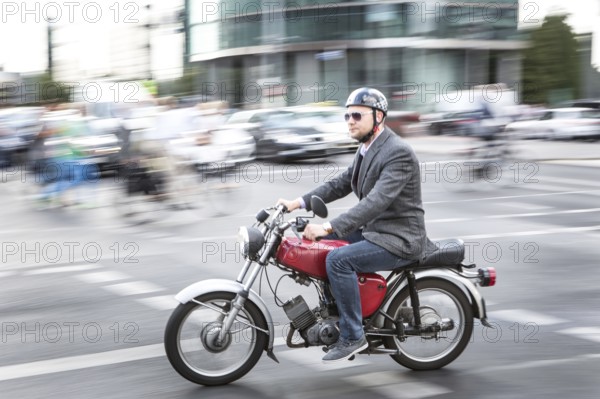 DEU Germany Germany Berlin Two-wheeled cyclists on a Simpson, an East German motorcycle company, walking around Potsdamer Platz