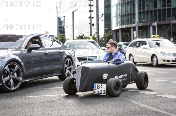 DEU Germany Germany Berlin A mini hot rod driver in traffic at Potsdamer Platz