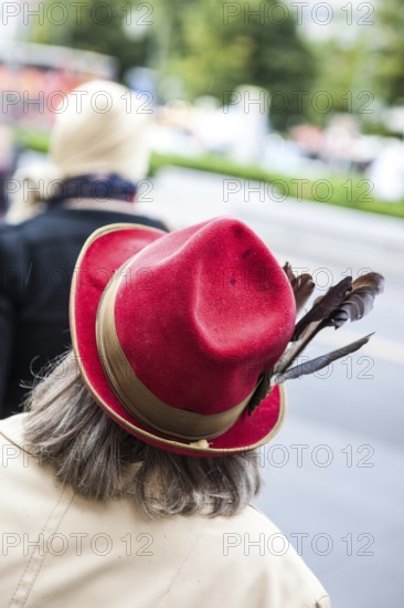 DEU Germany Germany Berlin Woman wearing red hat decorated with feathers
