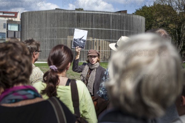 DEU Germany Germany Berlin city guide explains the history of the Wall and the border complex on Bernauer Straße in front of the Chapel of Reconciliation