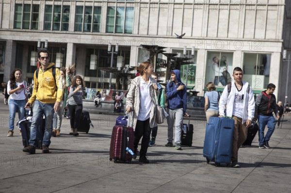 DEU Germany Germany Berlin Tourists pull their trolleys across Alexanderplatz