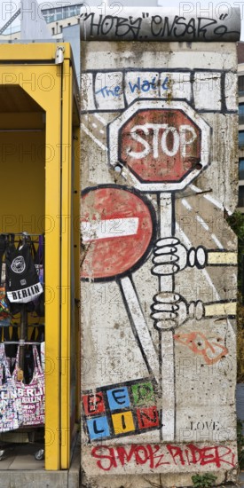 Old telephone box and painted piece of the Berlin Wall, gift shop Berlin loves you, Zimmerstraße, Berlin, Germany