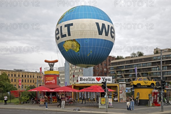 HiFlyer world balloon with the Berlin Loves You gift shop, Curry at the Wall snack bar and the Trabi sculpture, Zimmerstraße, Berlin, Germany