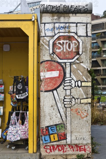 Old telephone box and painted piece of the Berlin Wall, gift shop Berlin loves you, Zimmerstraße, Berlin, Germany