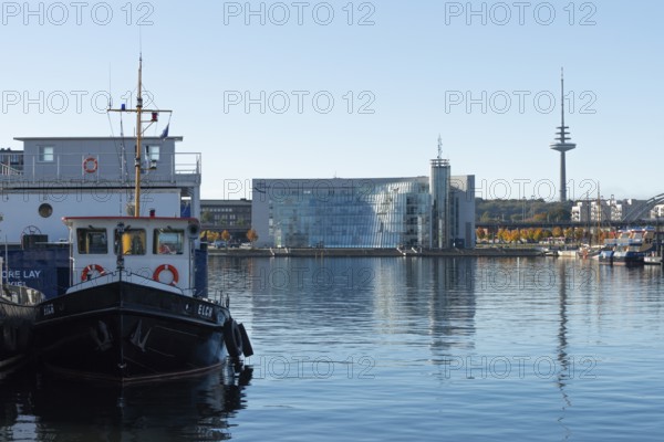 Harbor, Baltic Sea, city view Kiel, Kiel Fjord, shipping traffic, architecture, glass Hörn, wharf, pier, Sartori Berger Speicher, red brick building, telecommunications tower or television tower, Germany flag, sunshine, blue sky, Schleswig-Holstein, Germany