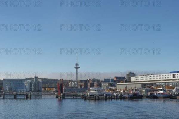 Harbor, Baltic Sea, city view Kiel, Kiel Fjord, shipping, regular ferry service, CAP adventure center, Hörnbrücke, folding bridge, architecture, glass Hörn campus, Hörn, telecommunications tower or television tower, haze layer, sunshine, blue sky, Schleswig-Holstein, Germany