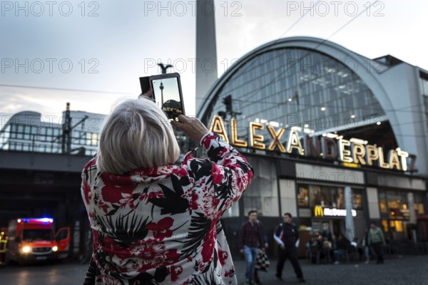 DEU Germany Germany Berlin tourist photographs the TV tower with her tablet