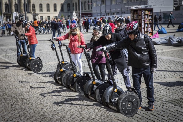 DEU Germany Germany Berlin A guided tourist group is getting ready to continue their journey with Segways on Bebelplatz