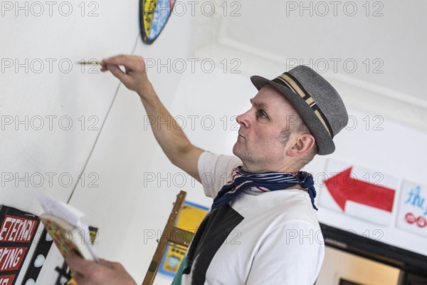DEU Germany Germany Berlin The artist Jim Avignon setting up an exhibition at the 'Retram' gallery in Berlin-Neukölln
