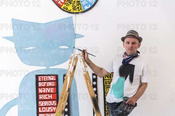 DEU Germany Germany Berlin The artist Jim Avignon setting up an exhibition at the 'Retram' gallery in Berlin-Neukölln
