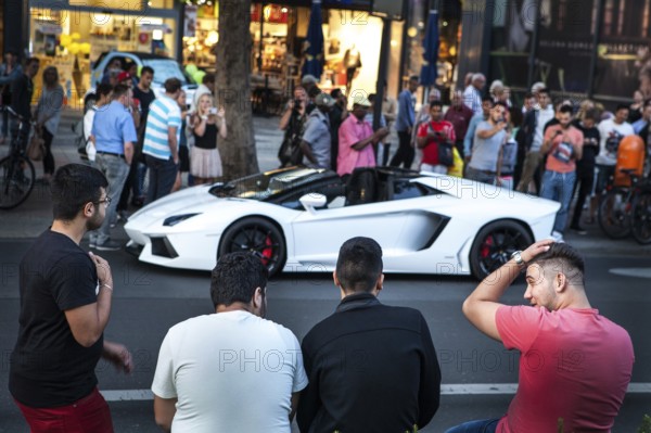 DEU Germany Germany Berlin A Lamborghini sports car is observed or photographed by passers-by on the Tauentzien. The driver got into a police checkpoint. Young people admire the luxury car from a distance