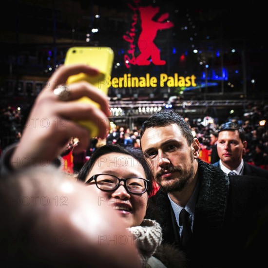 DEU Germany Germany Berlin 65th Berlinale, the international film festival in the German capital. James Franco with selfie-making fan on the red carpet for Wenders films 'Everything will be fine'