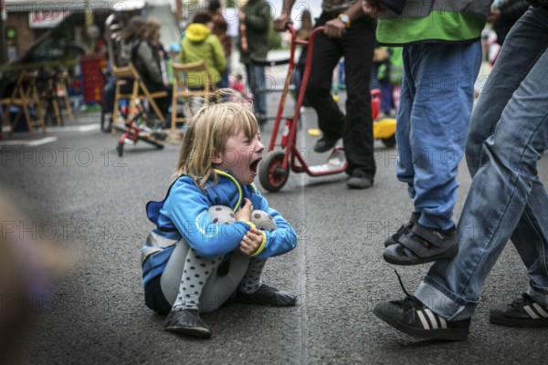 DEU Germany Germany Berlin Children play on Gudvanger Straße, which has been declared the city's first temporary play street. Parents, daycare and a school had worked to temporarily close the road on Oberen Prenzlauer Berg to road traffic