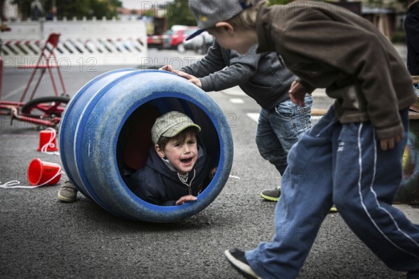 DEU Germany Germany Berlin Children play on Gudvanger Straße, which has been declared the city's first temporary play street. Parents, daycare and a school had worked to temporarily close the road on Oberen Prenzlauer Berg to road traffic