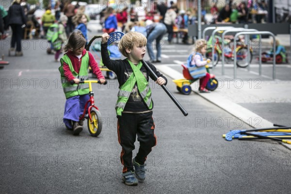 DEU Germany Germany Berlin Children play on Gudvanger Straße, which has been declared the city's first temporary play street. Parents, daycare and a school had worked to temporarily close the road on Oberen Prenzlauer Berg to road traffic