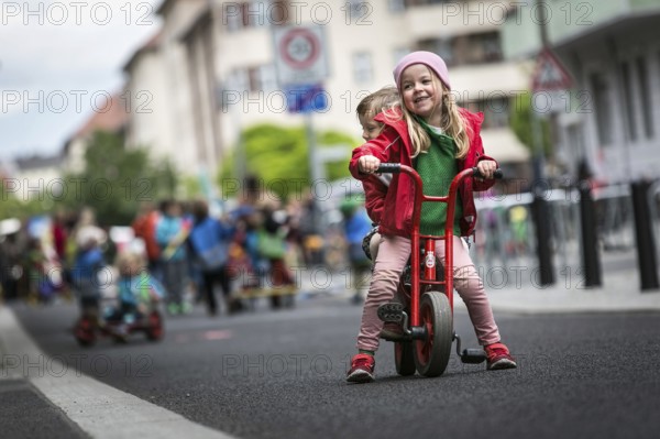 DEU Germany Germany Berlin Children play on Gudvanger Straße, which has been declared the city's first temporary play street. Parents, daycare and a school had worked to temporarily close the road on Oberen Prenzlauer Berg to road traffic