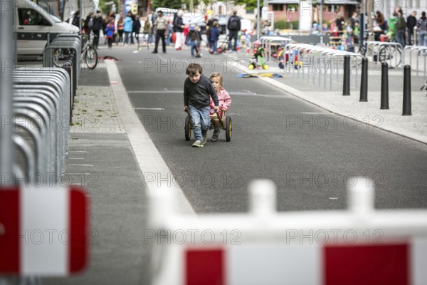DEU Germany Germany Berlin Children play on Gudvanger Straße, which has been declared the city's first temporary play street. Parents, daycare and a school had worked to temporarily close the road on Oberen Prenzlauer Berg to road traffic