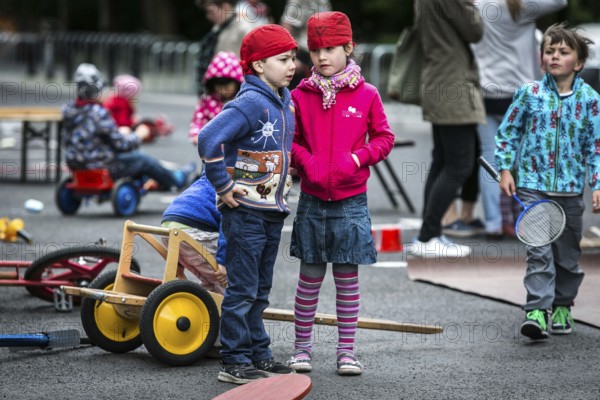 DEU Germany Germany Berlin Children play on Gudvanger Straße, which has been declared the city's first temporary play street. Parents, daycare and a school had worked to temporarily close the road on Oberen Prenzlauer Berg to road traffic