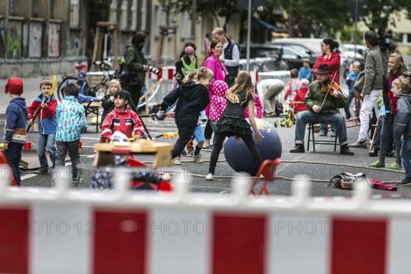 DEU Germany Germany Berlin Children play on Gudvanger Straße, which has been declared the city's first temporary play street. Parents, daycare and a school had worked to temporarily close the road on Oberen Prenzlauer Berg to road traffic