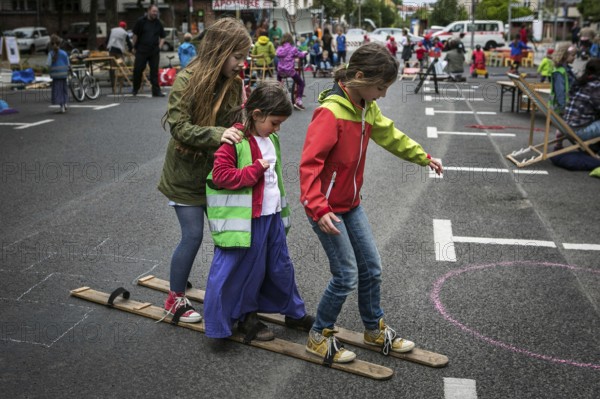 DEU Germany Germany Berlin Children play on Gudvanger Straße, which has been declared the city's first temporary play street. Parents, daycare and a school had worked to temporarily close the road on Oberen Prenzlauer Berg to road traffic