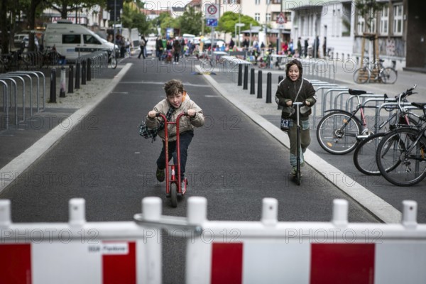 DEU Germany Germany Berlin Children play on Gudvanger Straße, which has been declared the city's first temporary play street. Parents, daycare and a school had worked to temporarily close the road on Oberen Prenzlauer Berg to road traffic