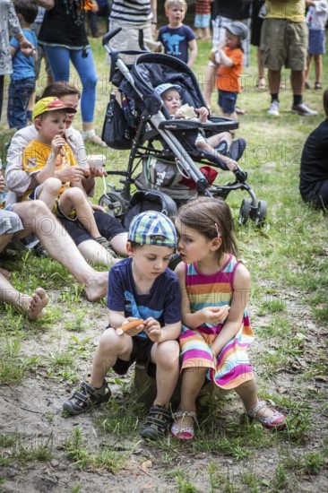 DEU Germany Germany Berlin Summer party at the Northwest daycare center on Prager Platz. Children whispering