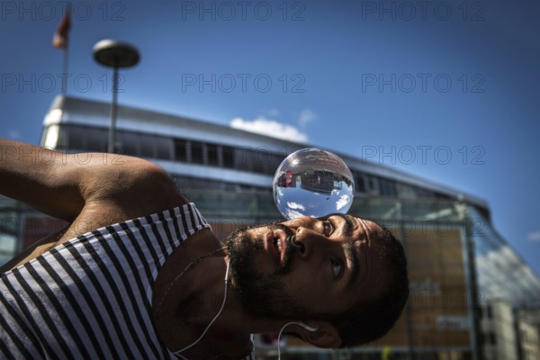 DEU Germany Germany Berlin Juggler with crystal ball works at the intersection opposite the CDU federal party headquarters