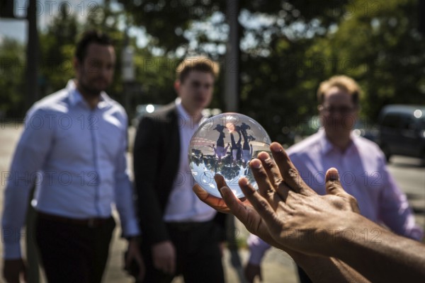 DEU Germany Germany Berlin Juggler with crystal ball works at the intersection opposite the CDU federal party headquarters