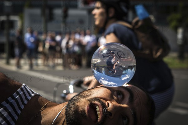 DEU Germany Germany Berlin Juggler with crystal ball works at the intersection opposite the CDU federal party headquarters