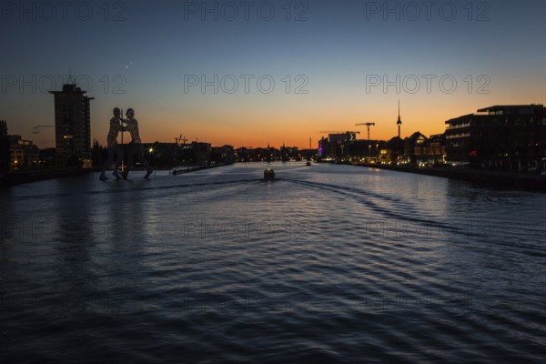 DEU Germany Germany Berlin View over Osthafen across the Spree towards Alex at sunset