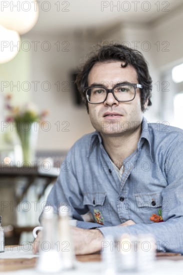 DEU Germany Germany Berlin The writer Phillip Schönthaler during a portrait appointment at the Morena Cafe in Kreuzberg