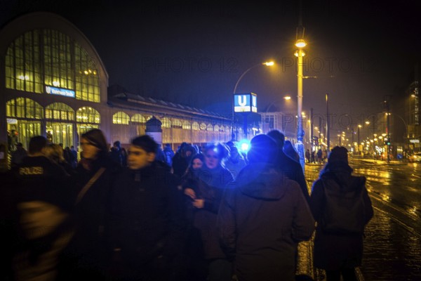 DEU Germany Germany Berlin Scene on the Warsaw Bridge in Berlin-Friedrichshain.People against a blue light from a police patrol at the Warschauer Straße subway station