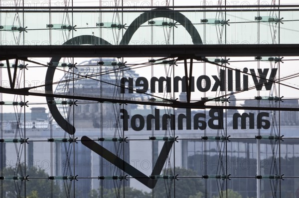 View from Central Station of the Reichstag dome with the inverted lettering Welcome to the Station on the glass façade, Berlin, Germany