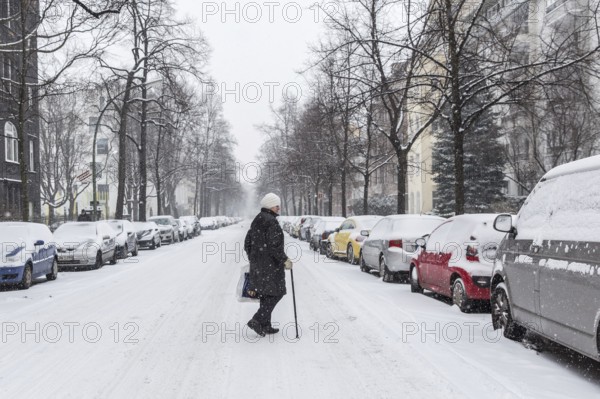 DEU Germany Germany Berlin Walking on snow-covered road in Schöneberg