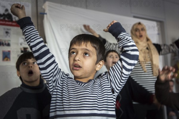DEU Germany Germany Berlin An animation team entertains refugee children in an asylum center in Berlin