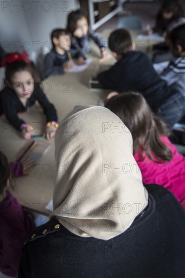DEU Germany Germany Berlin An animation team entertains refugee children in an asylum center in Berlin