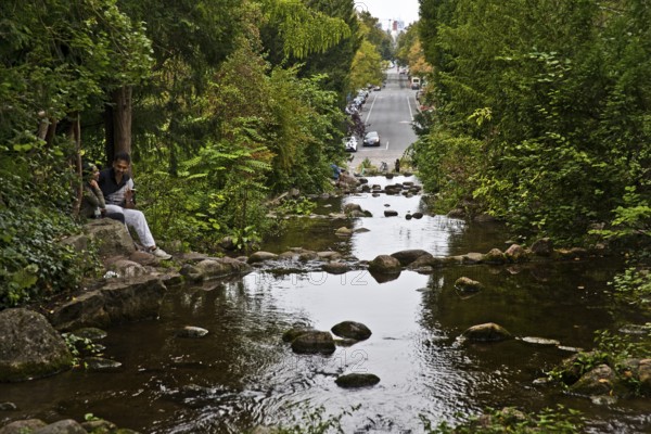 Artificial waterfall in Victoria Park with Großbeerenstraße in the background, Berlin-Kreuzberg, Berlin, Germany