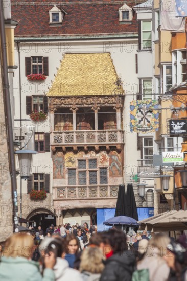 Golden roof, lots of people and historic houses in Herzog-Friedrich-Straße, Altstadt, Innsbruck, Tyrol, Austria