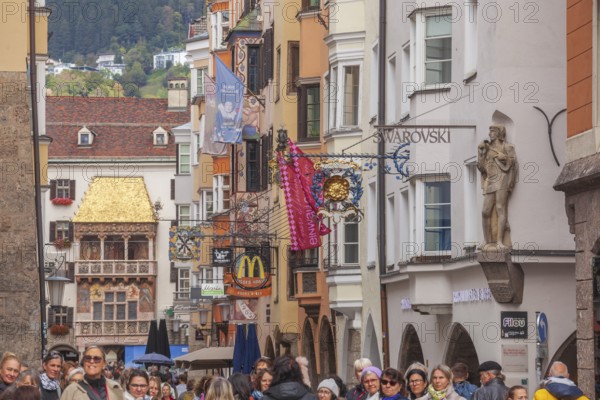 Golden roof, lots of people and historic houses in Herzog-Friedrich-Straße, Altstadt, Innsbruck, Tyrol, Austria