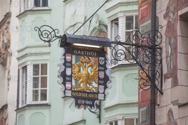 Old hanging sign from Gasthof Goldener Adler in Herzog-Friedrich-Straße, Old Town, Innsbruck, Tyrol, Austria