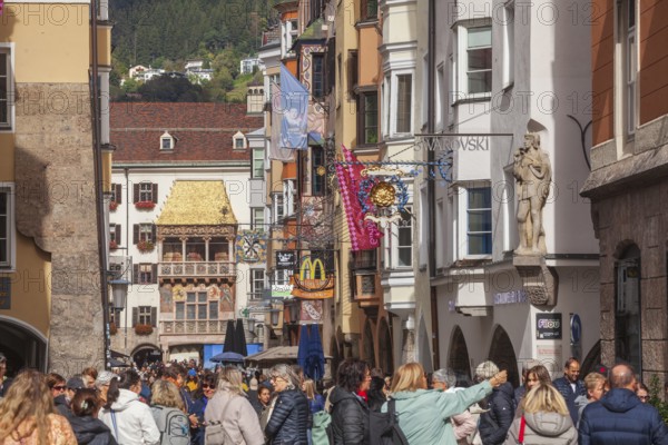 Golden roof, lots of people and historic houses in Herzog-Friedrich-Straße, Altstadt, Innsbruck, Tyrol, Austria