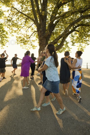People dancing in the sun, Promenade, Bregenz, Lake Constance, Vorarlberg, Austria