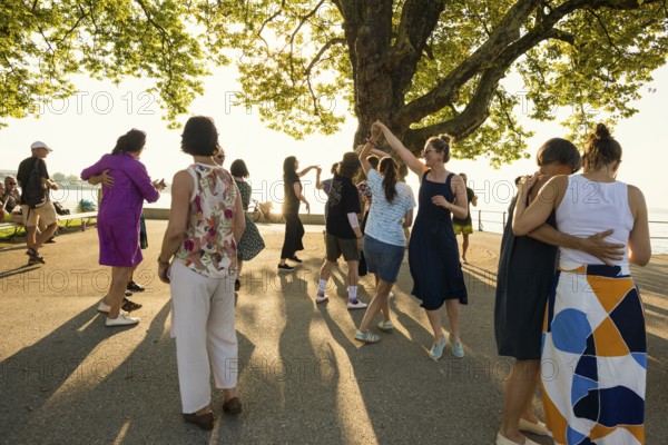 People dancing in the sun, Promenade, Bregenz, Lake Constance, Vorarlberg, Austria